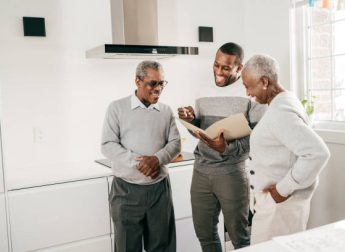 Insurance broker and seniors in the kitchen Insurance broker and seniors in the kitchen